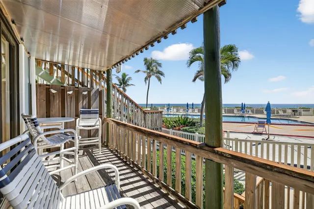 a view of a balcony with wooden floor