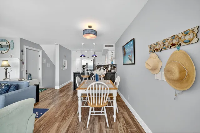 a view of a dining room with furniture and wooden floor