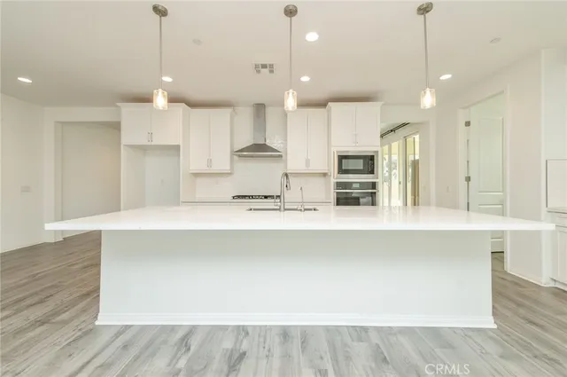a large kitchen with stainless steel appliances kitchen island a large island in the center