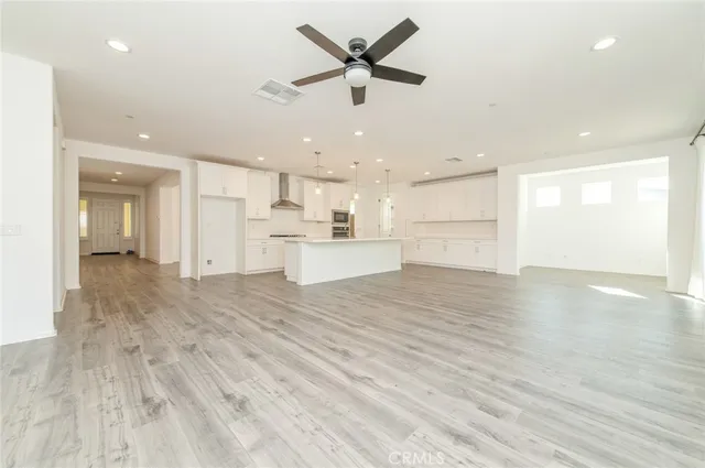 a view of a kitchen with a stove cabinets and wooden floor