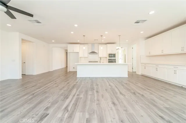 a view of a kitchen with wooden floor and windows