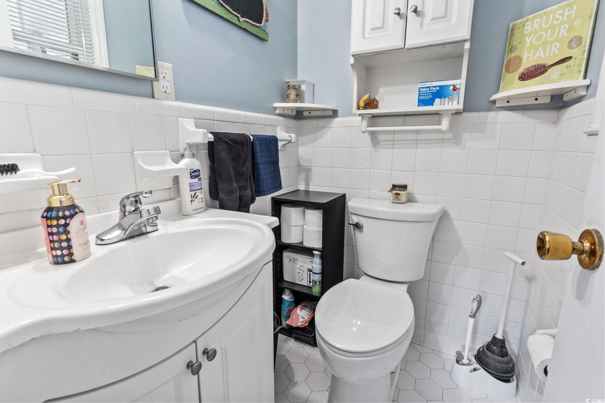 948 Heritage Road Loris, SC 29569 - Photo 13 of 21 Bathroom featuring tile walls, vanity, toilet, and