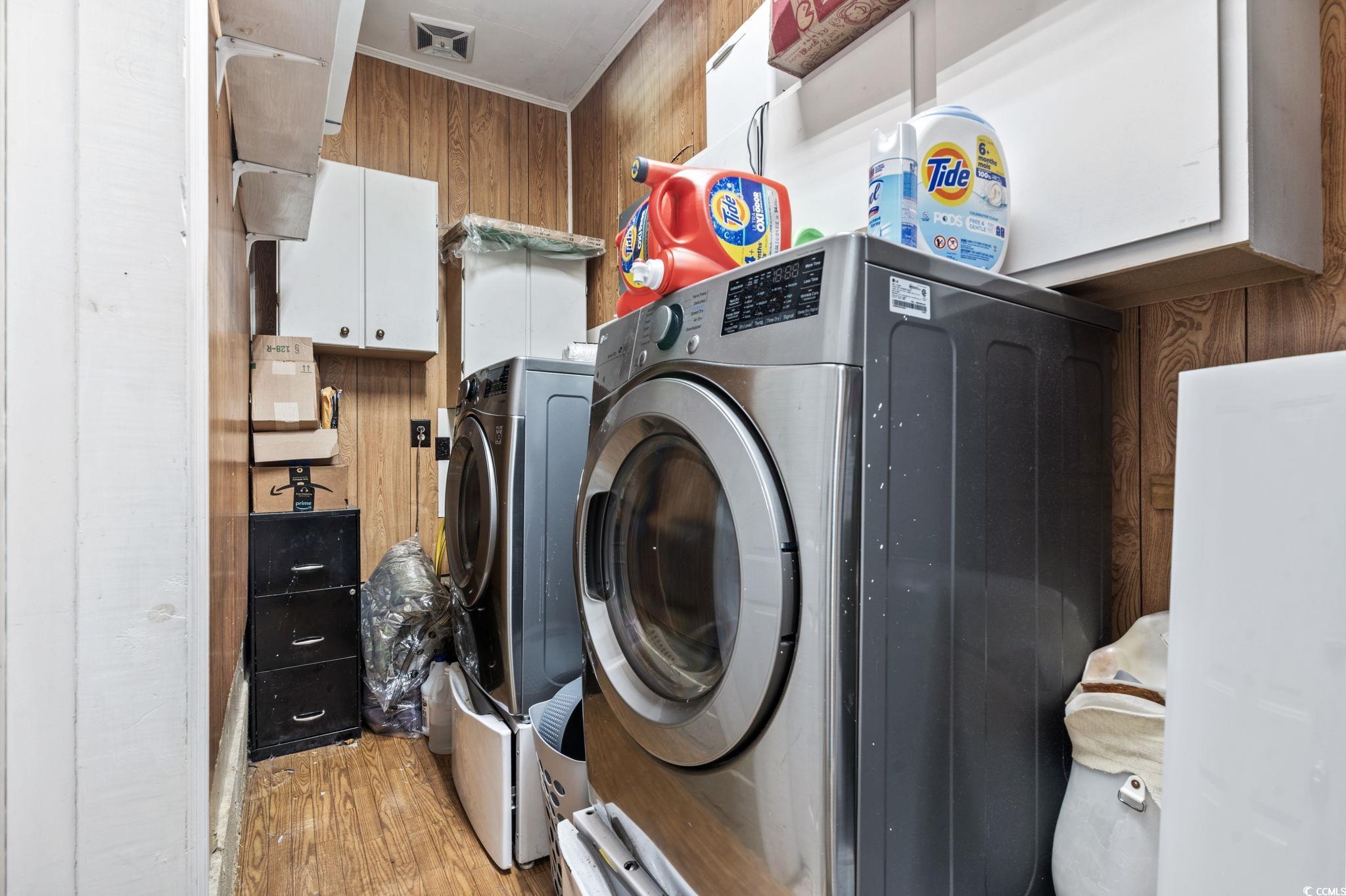 948 Heritage Road Loris, SC 29569 - Photo 14 of 21 Clothes washing area featuring wooden walls, light
