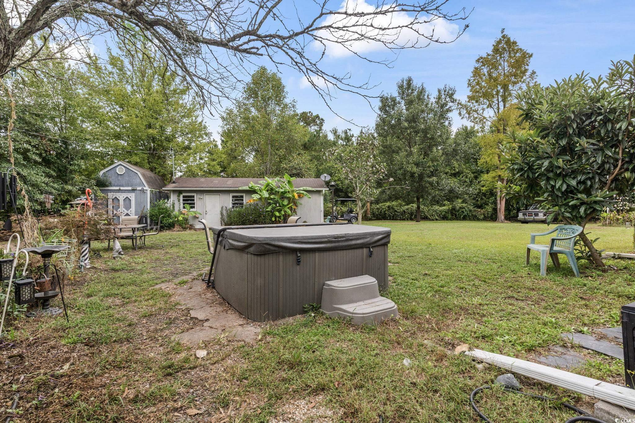 948 Heritage Road Loris, SC 29569 - Photo 16 of 21 View of yard with a hot tub and an outbuilding