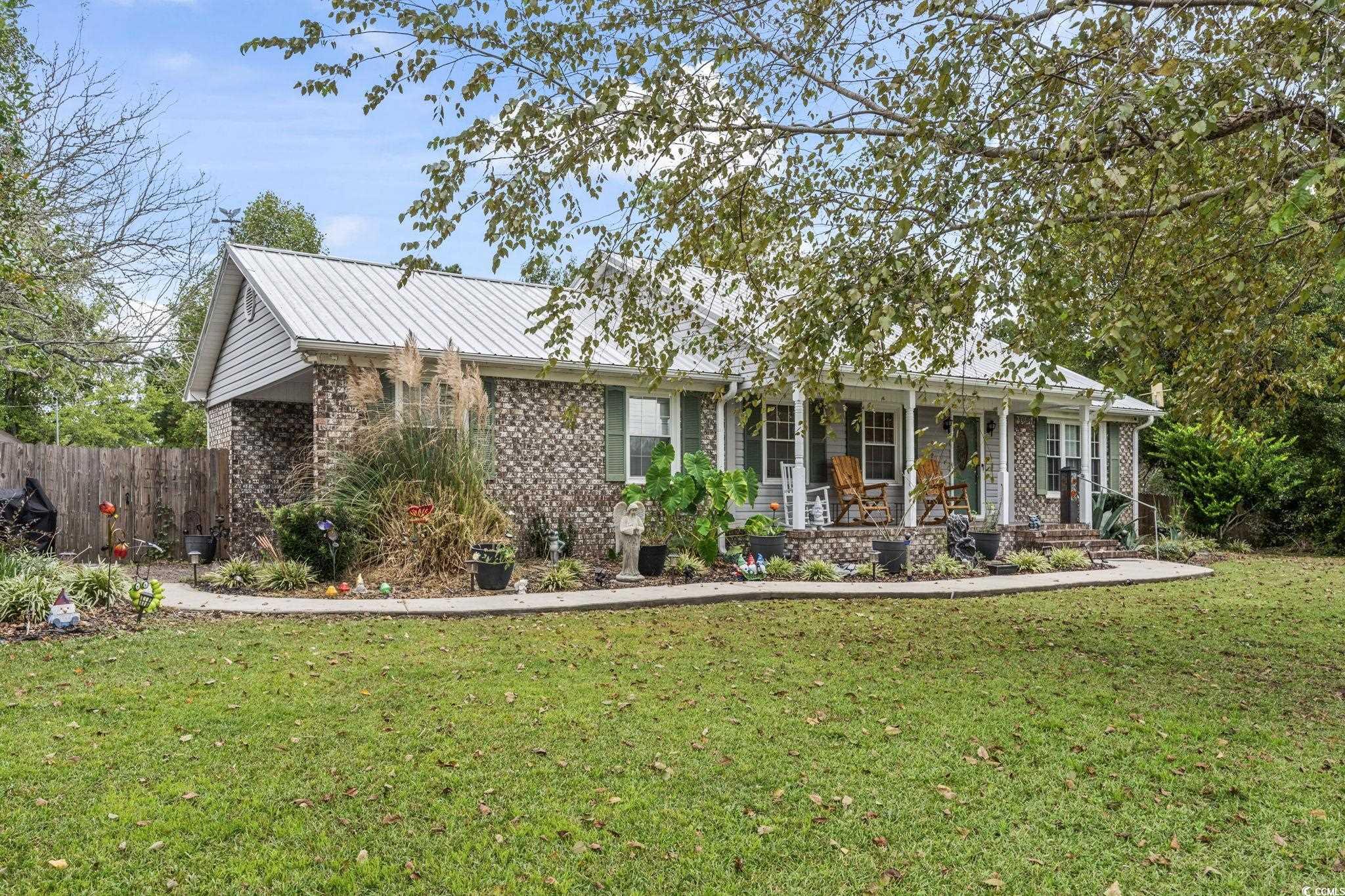 948 Heritage Road Loris, SC 29569 - Photo 2 of 21 View of front of home with a front yard and a porc