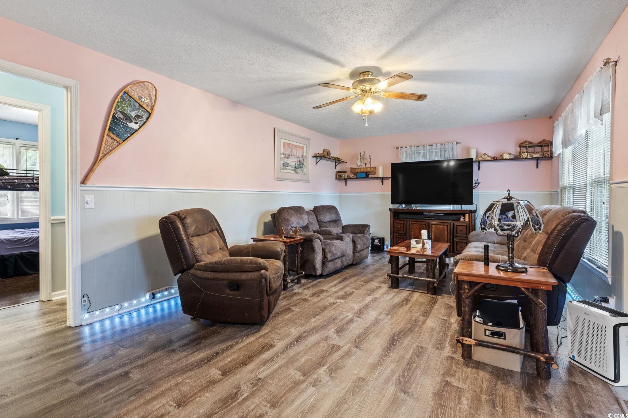 948 Heritage Road Loris, SC 29569 - Photo 5 of 21 Living room featuring a textured ceiling, hardwood