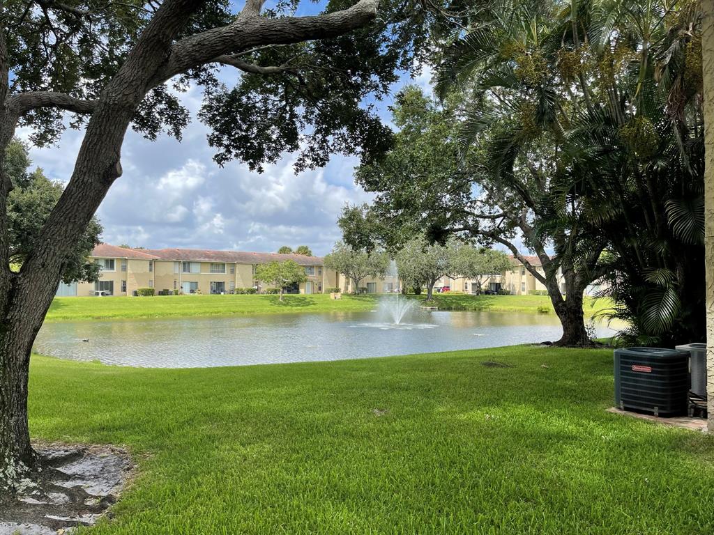 9971 Twin Lakes Drive, Unit 9G Coral Springs, FL 33071 - Photo 13 of 13 a view of swimming pool with a yard and a large tree