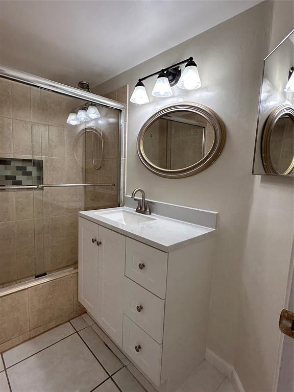 9971 Twin Lakes Drive, Unit 9G Coral Springs, FL 33071 - Photo 5 of 13 a bathroom with a sink mirror a toilet and a shower