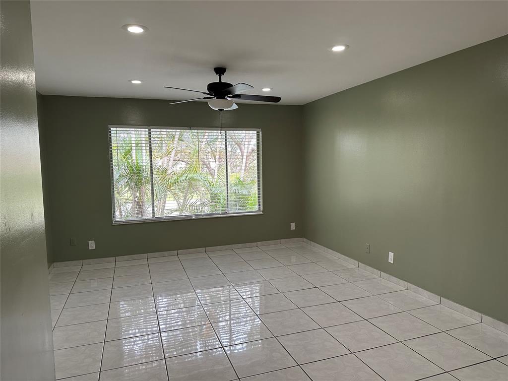9971 Twin Lakes Drive, Unit 9G Coral Springs, FL 33071 - Photo 7 of 13 an empty room with windows and fan