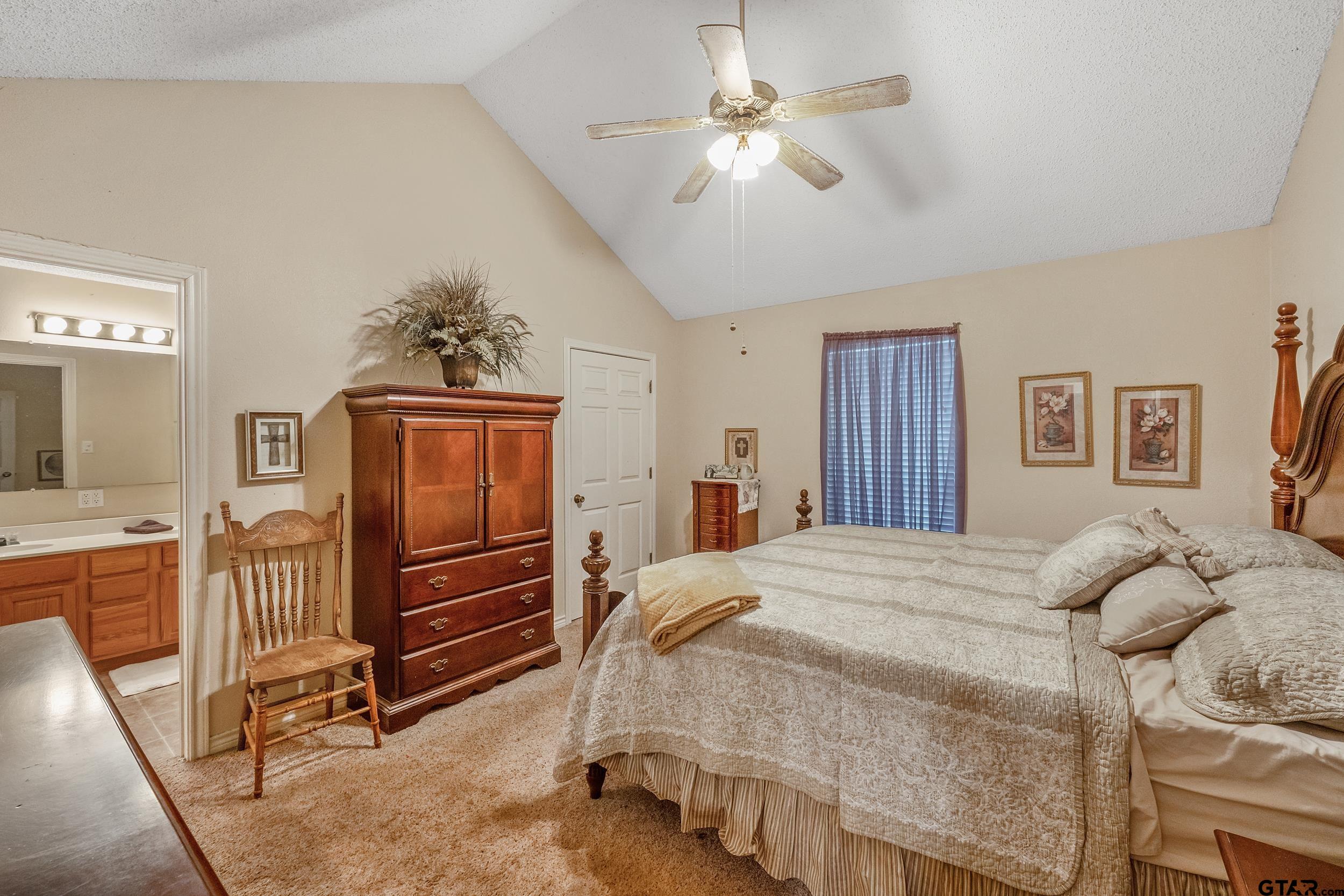233 Easy Street Rusk, TX 75785 - Photo 4 of 18 a bedroom with a bed dresser and wooden floor