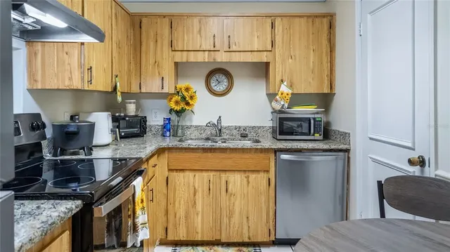 a kitchen with a sink and a refrigerator