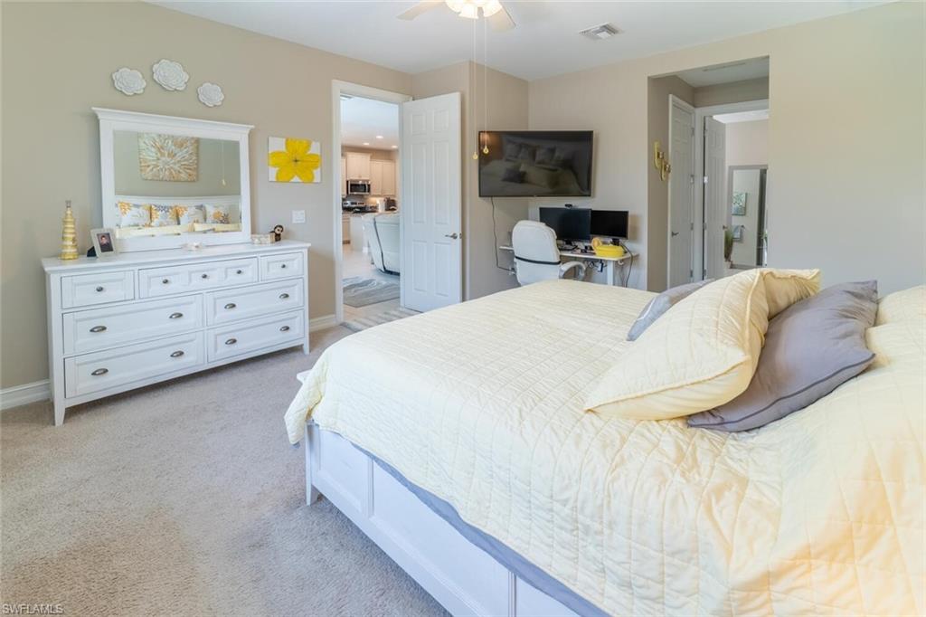 16366 Barclay Court Naples, FL 34110 - Photo 14 of 35 a bedroom with a bed and a dresser in it