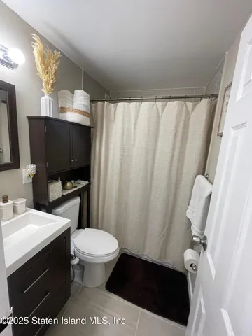 a view of a chair and tables in the balcony
