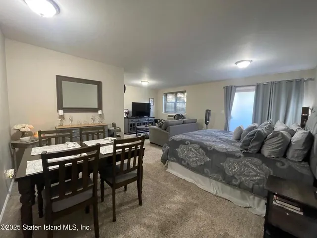 a living room with furniture a clock and a table