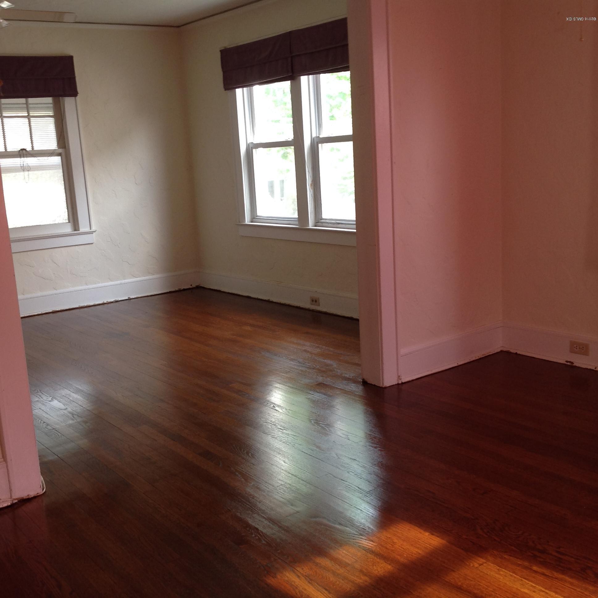 40 Sheep Hill Road Riverside, CT 06878 - Photo 3 of 11 an empty room with wooden floor and windows