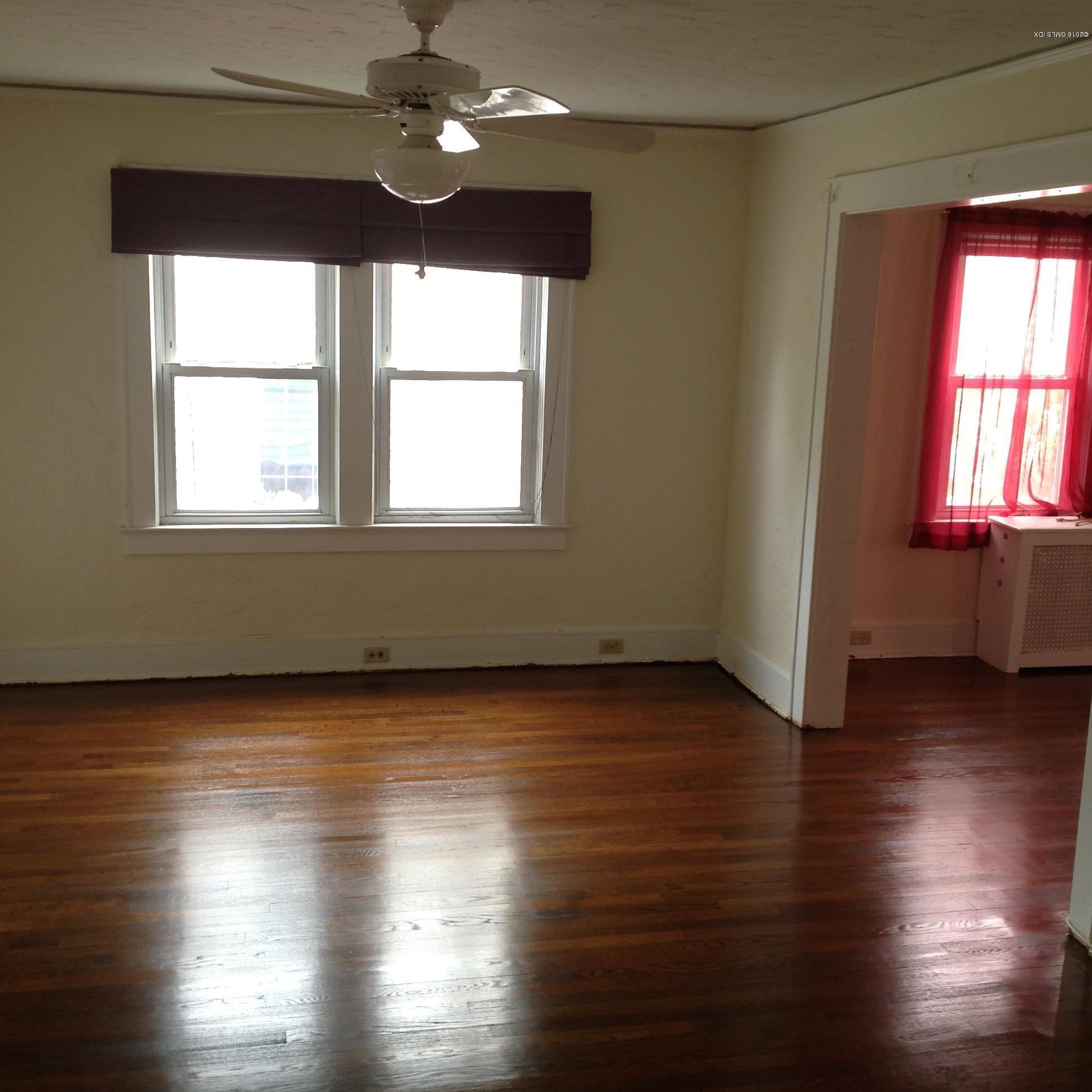 40 Sheep Hill Road Riverside, CT 06878 - Photo 4 of 11 an empty room with wooden floor and windows