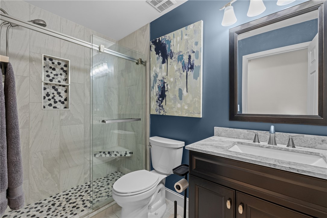 433 Harts Cove Way Seneca, SC 29678 - Photo 5 of 24 Ba 1 - tiled to ceiling, pebble tile floor, glass shower door, new vanities