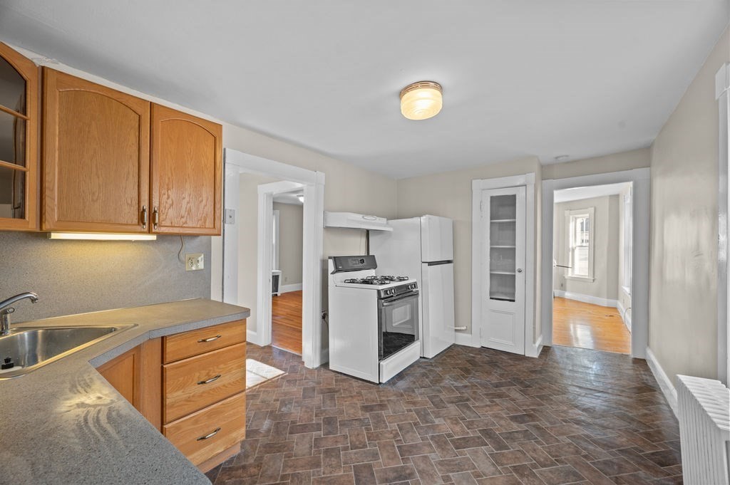 13 Giles Avenue, Unit 2 Beverly, MA 01915 - Photo 11 of 27 a kitchen with stainless steel appliances granite countertop a refrigerator and a stove top oven