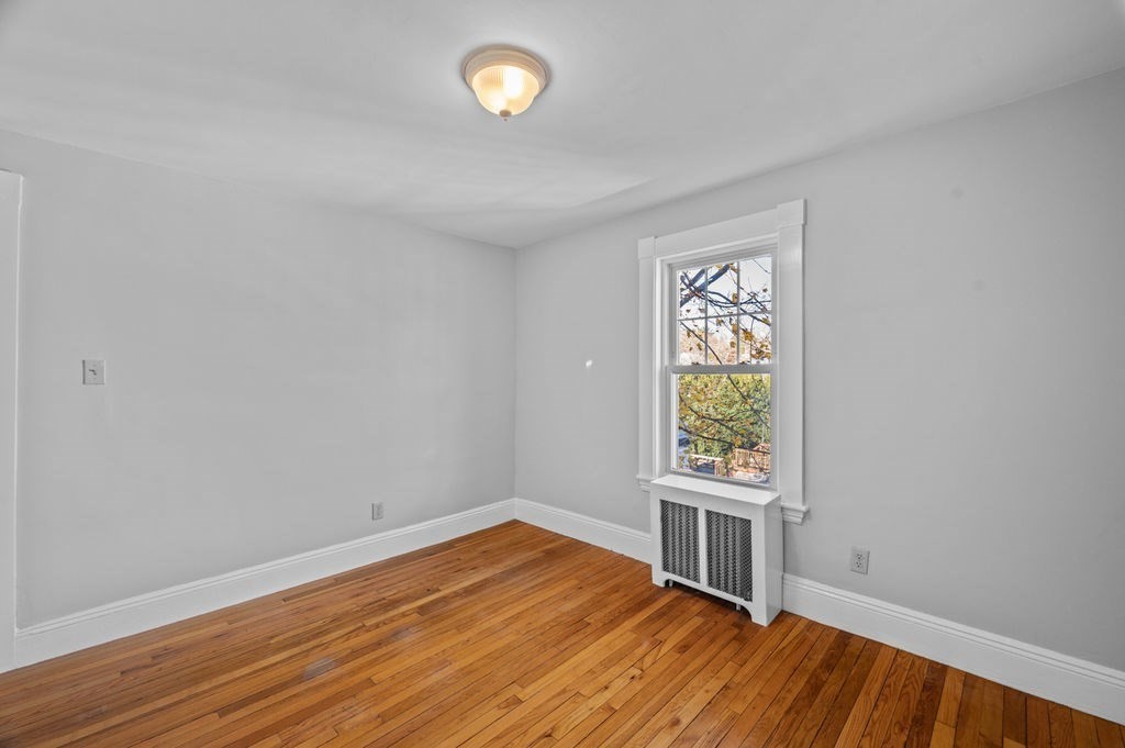 13 Giles Avenue, Unit 2 Beverly, MA 01915 - Photo 14 of 27 a view of a room with wooden floor and windows