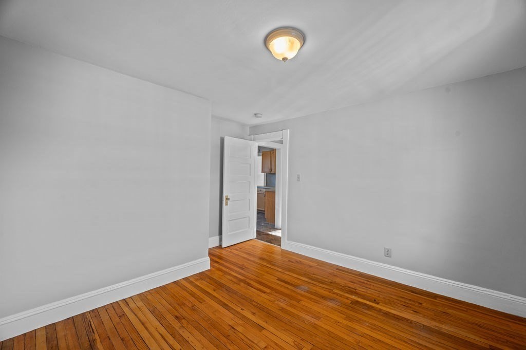 13 Giles Avenue, Unit 2 Beverly, MA 01915 - Photo 15 of 27 a view of empty room with wooden floor
