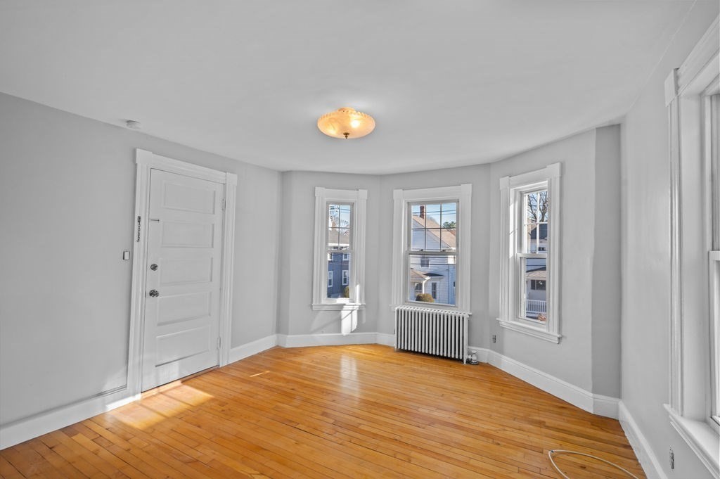 13 Giles Avenue, Unit 2 Beverly, MA 01915 - Photo 5 of 27 a view of an empty room with window and wooden floor
