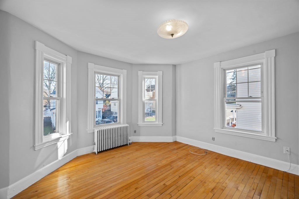 13 Giles Avenue, Unit 2 Beverly, MA 01915 - Photo 6 of 27 an empty room with windows