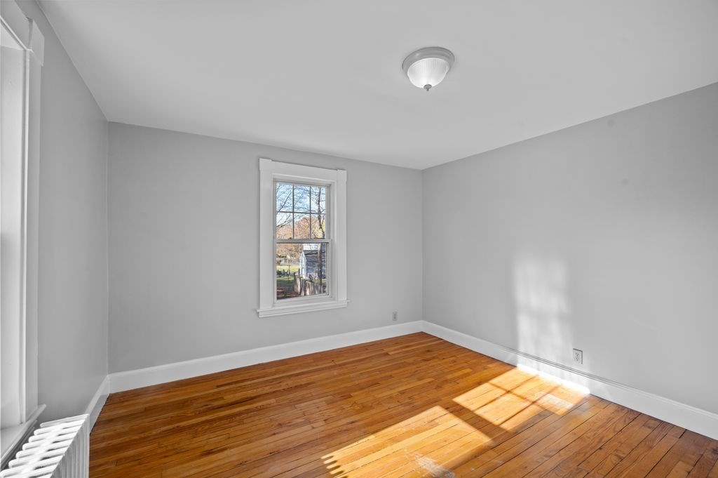 13 Giles Avenue, Unit 2 Beverly, MA 01915 - Photo 7 of 27 a view of empty room with wooden floor and fan