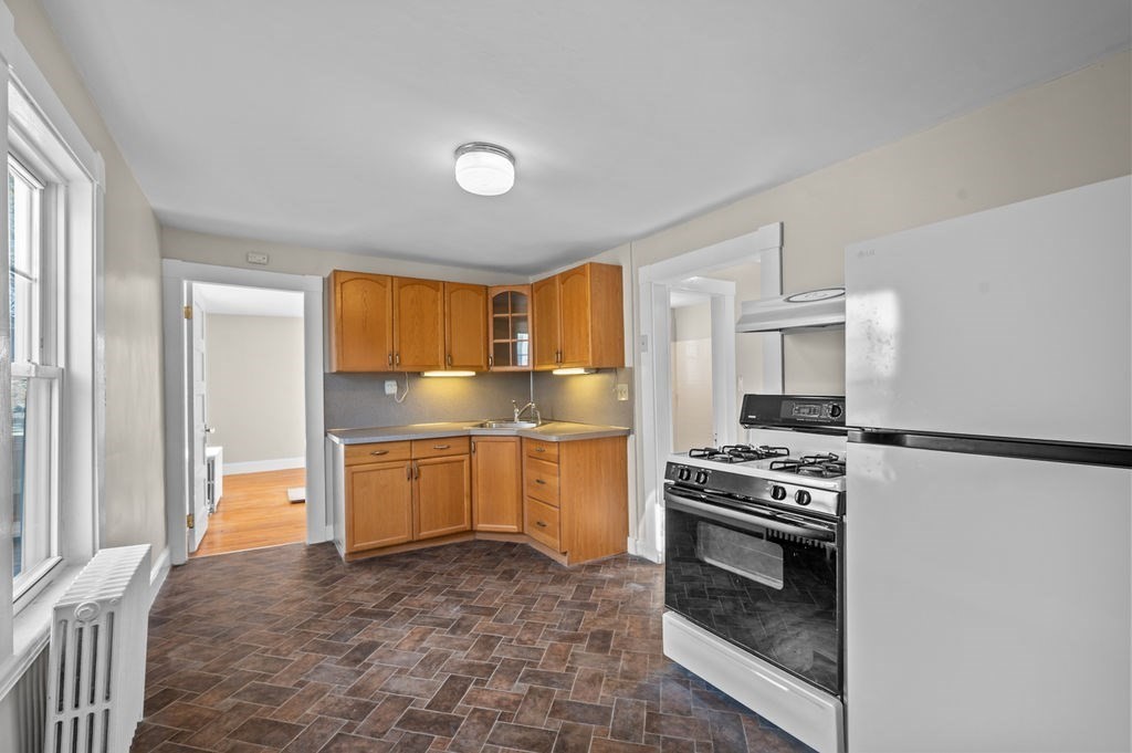 13 Giles Avenue, Unit 2 Beverly, MA 01915 - Photo 10 of 27 a kitchen with a stove a sink and a refrigerator