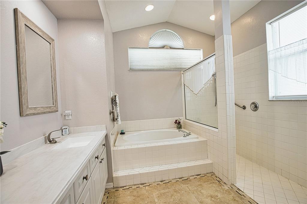 4398 Summertree Road Venice, FL 34293 - Photo 19 of 38 a bathroom with a tub sink and mirror