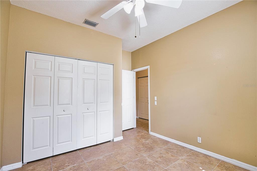 4398 Summertree Road Venice, FL 34293 - Photo 23 of 38 an empty room with a ceiling fan