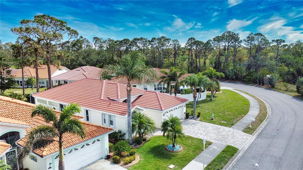 4398 Summertree Road Venice, FL 34293 - Photo 37 of 38 a view of a house with a yard and potted plants