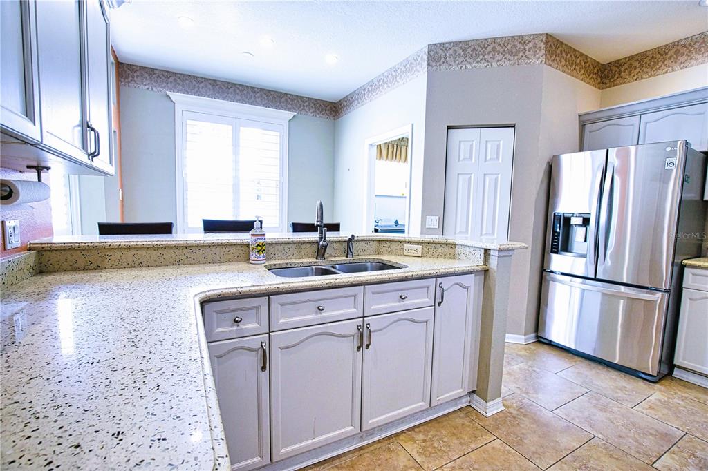 4398 Summertree Road Venice, FL 34293 - Photo 6 of 38 a kitchen with stainless steel appliances granite countertop a refrigerator sink and cabinets