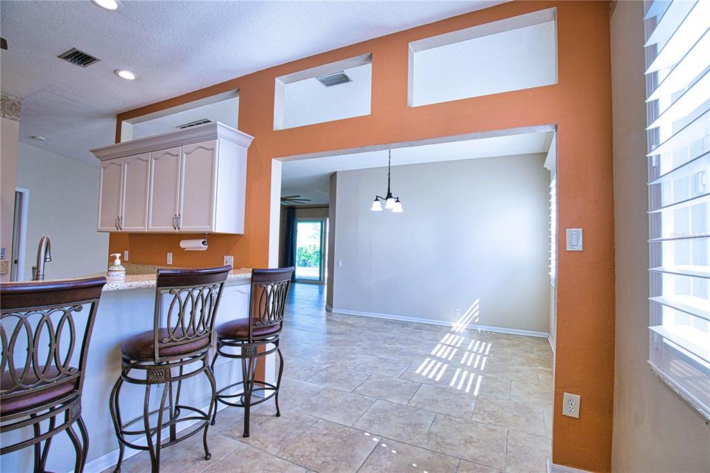4398 Summertree Road Venice, FL 34293 - Photo 8 of 38 a view of dining room and kitchen with a window