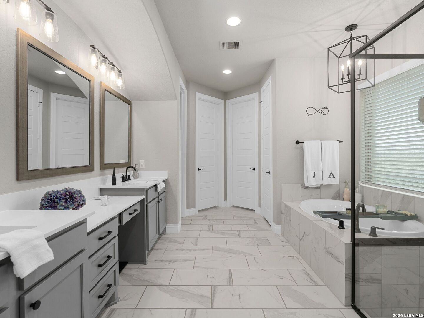 10281 Headwind Boerne, TX 78006 - Photo 16 of 45 a spacious bathroom with a granite countertop sink a toilet a mirror and shower