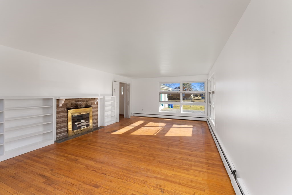 110 Fieldwood Avenue Seekonk, MA 02771 - Photo 16 of 33 a view of an empty room with a fireplace and a window