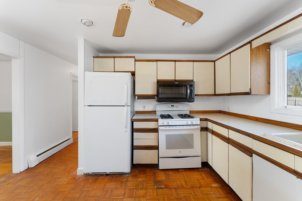 110 Fieldwood Avenue Seekonk, MA 02771 - Photo 10 of 33 a kitchen with white cabinets and white appliances