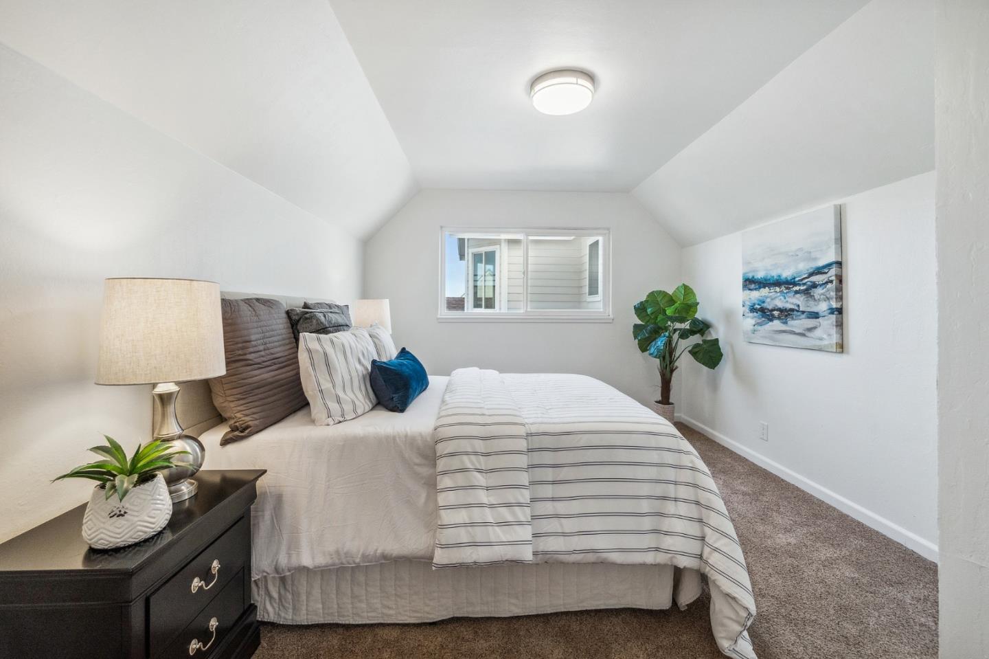 548 Inverness Drive Pacifica, CA 94044 - Photo 18 of 24 a bedroom with a bed and painting on the wall
