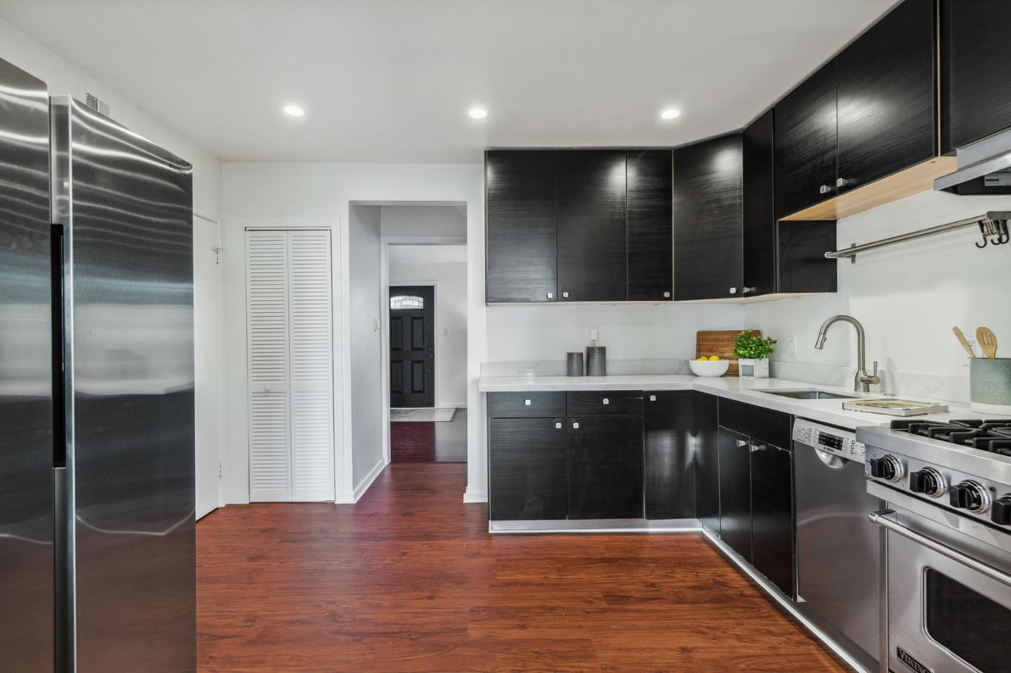 548 Inverness Drive Pacifica, CA 94044 - Photo 4 of 24 a kitchen with stainless steel appliances granite countertop a stove a sink and a refrigerator