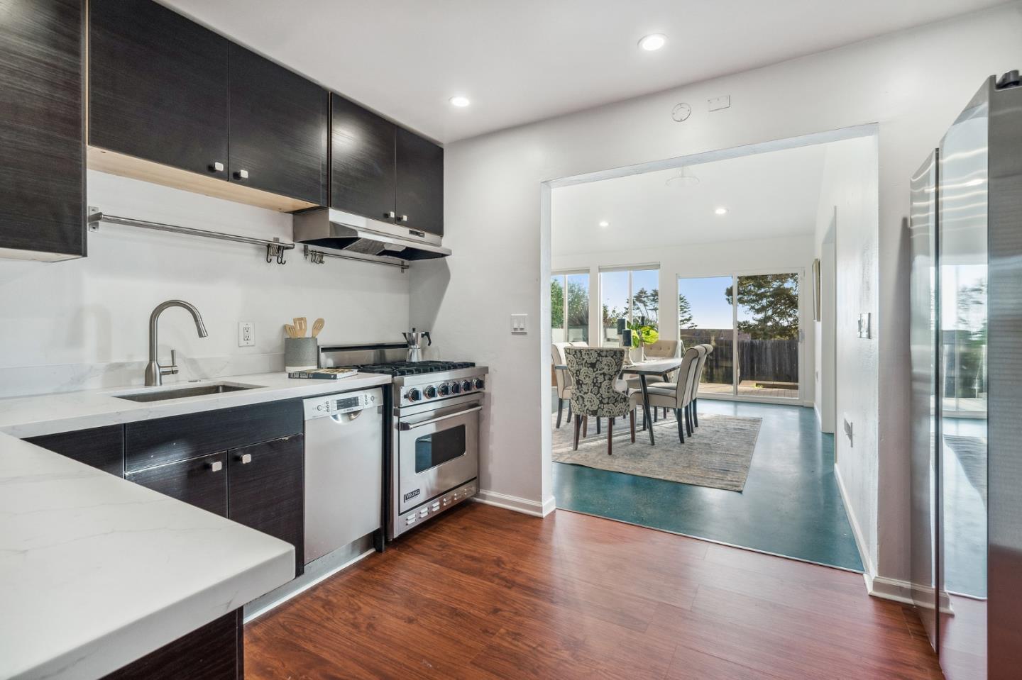 548 Inverness Drive Pacifica, CA 94044 - Photo 6 of 24 a kitchen with granite countertop a stove a sink and a refrigerator