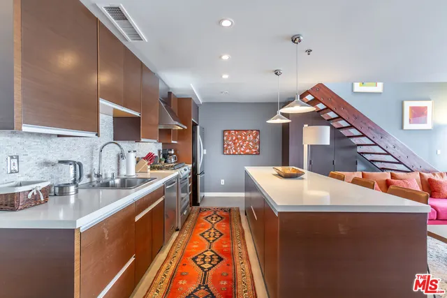 a kitchen that has a sink and a stove in it