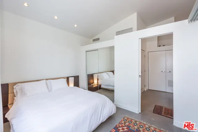 a bedroom with a bed and a lamp