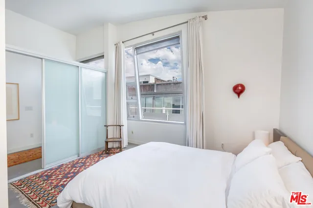 a bedroom with a bed and a window