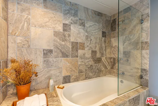 a bath tub sitting next to a blue toilet