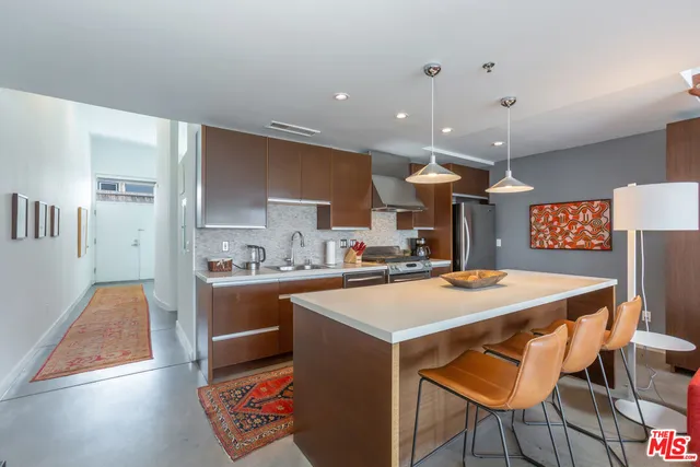 a large kitchen with a table and chairs
