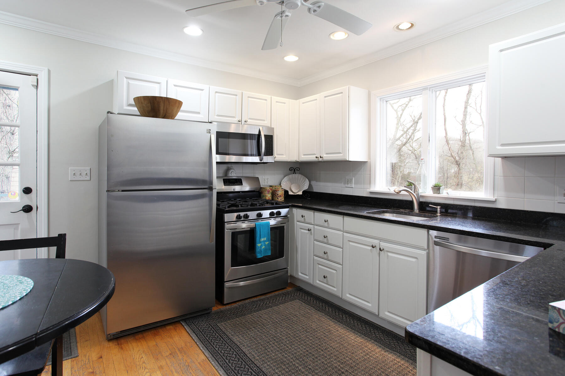 321 Tower Hill Road Osterville, MA 02655 - Photo 23 of 43 a kitchen with stainless steel appliances granite countertop a sink refrigerator and microwave
