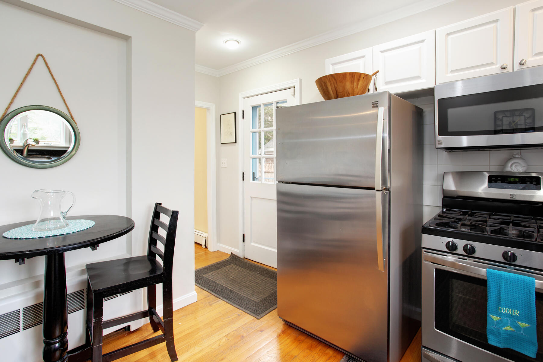 321 Tower Hill Road Osterville, MA 02655 - Photo 24 of 43 a kitchen with stainless steel appliances granite countertop a refrigerator a stove a sink and a dining table with wooden floor
