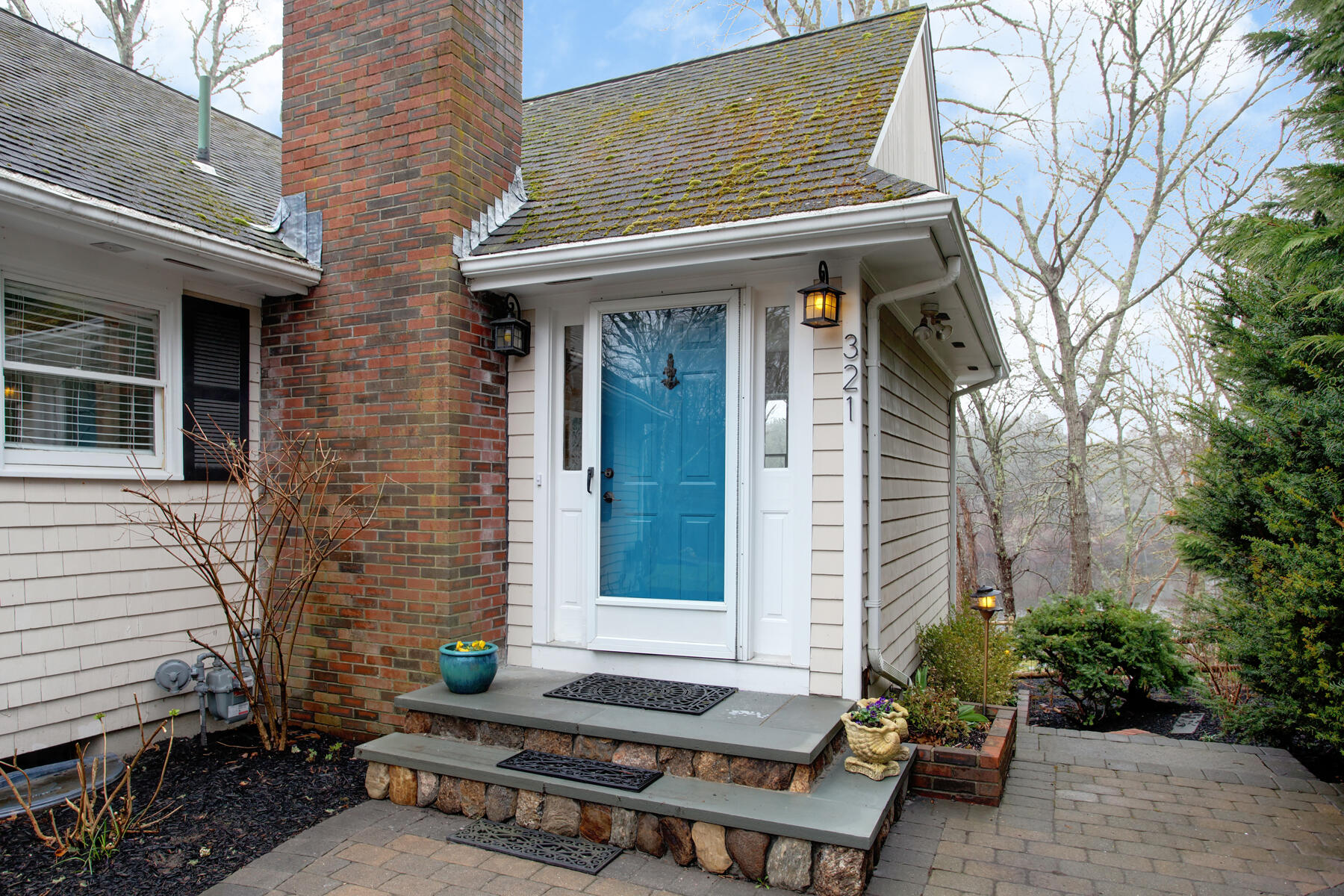 321 Tower Hill Road Osterville, MA 02655 - Photo 3 of 43 a view of a brick house with chairs and table in a patio