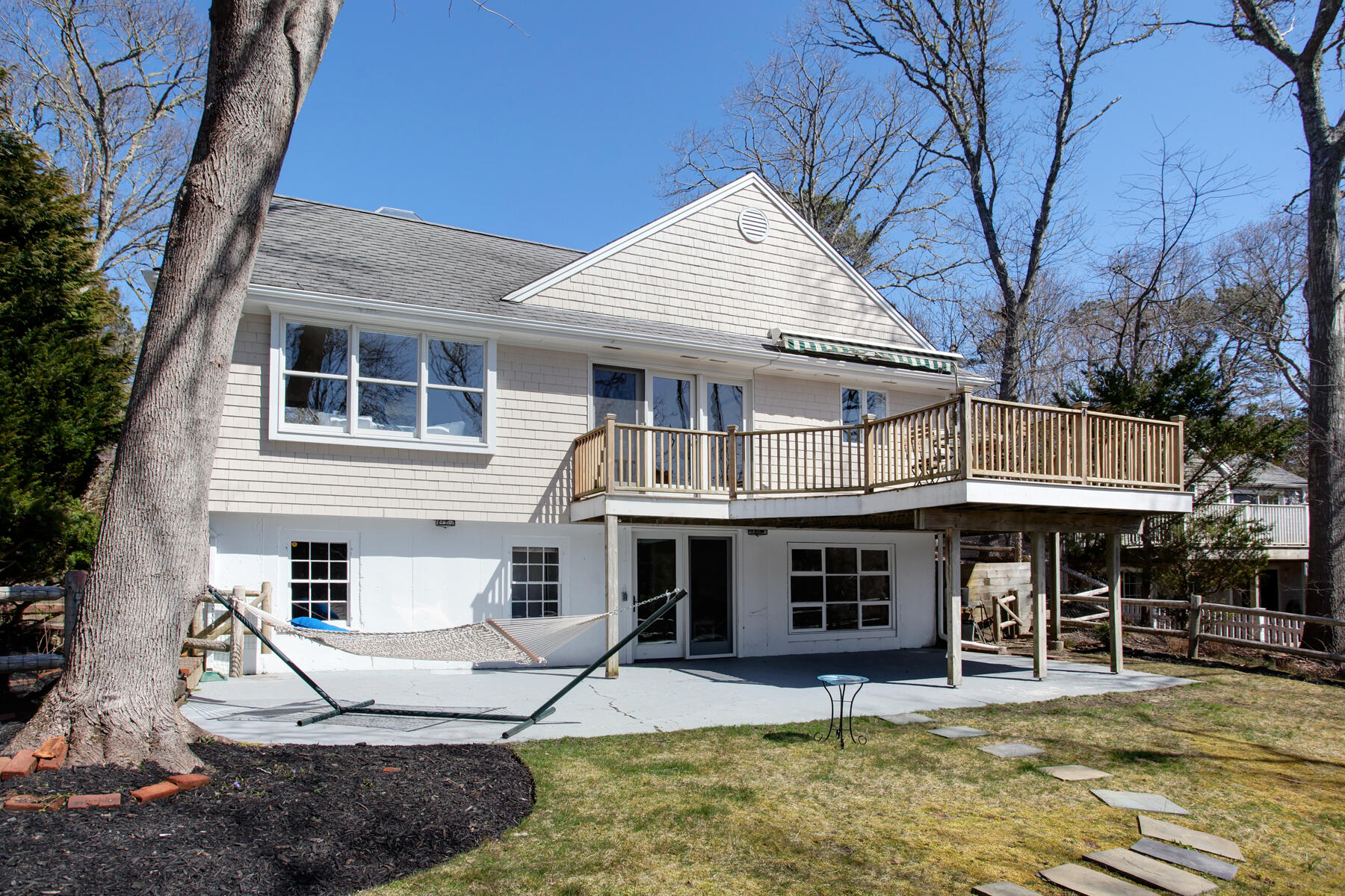 321 Tower Hill Road Osterville, MA 02655 - Photo 7 of 43 a front view of a house with a yard balcony and seating area