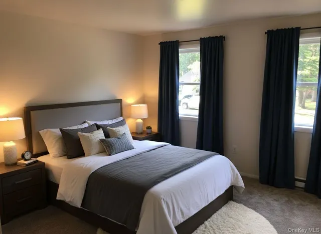 a bedroom with a bed and large window