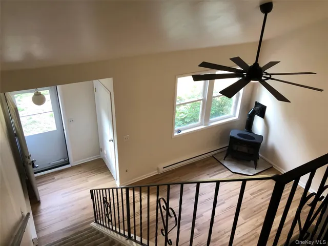 a view of entryway with a window and wooden floor
